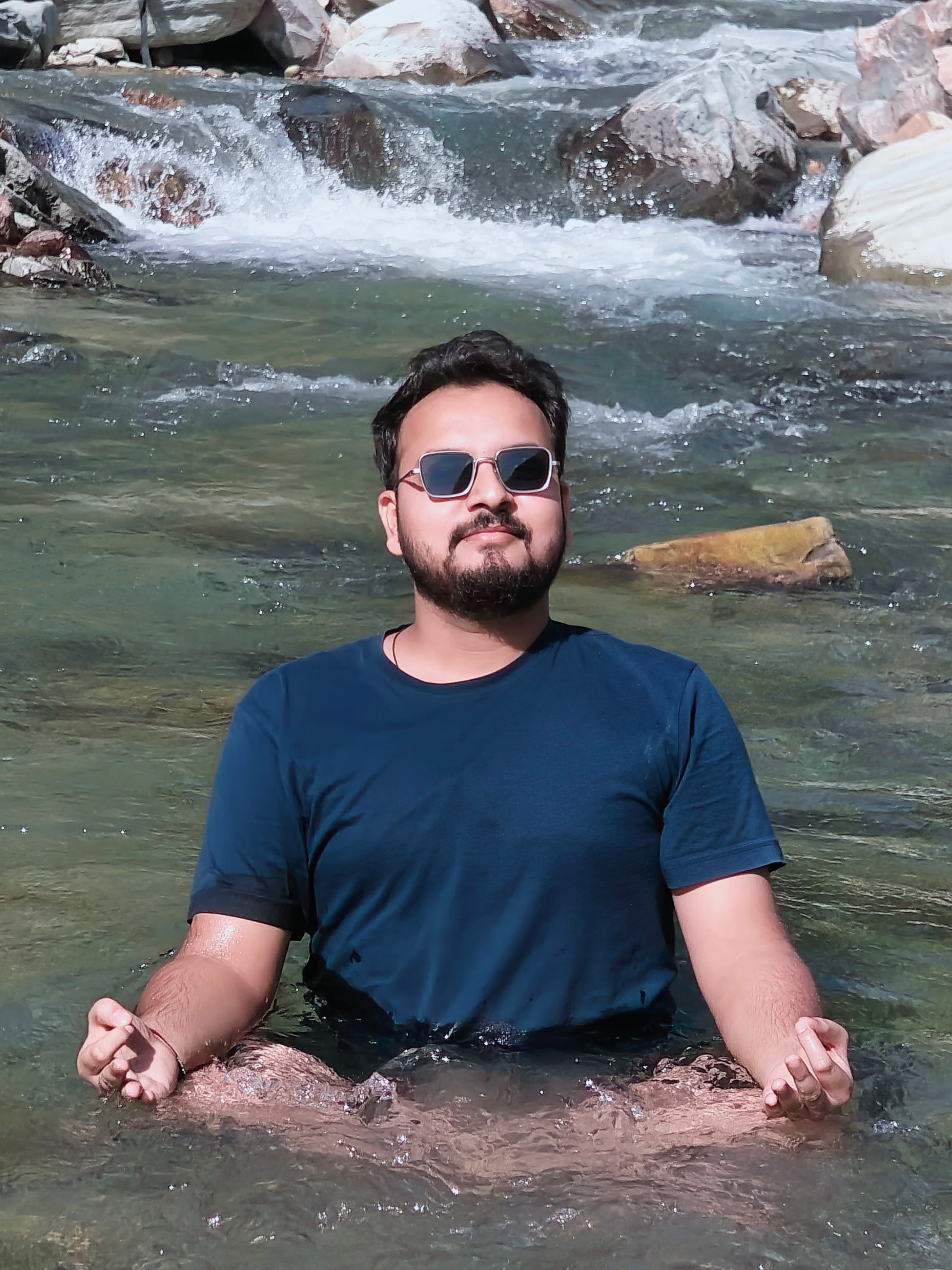 Me sitting in the mountain stream near Blue Lotus with a small cascade behind me