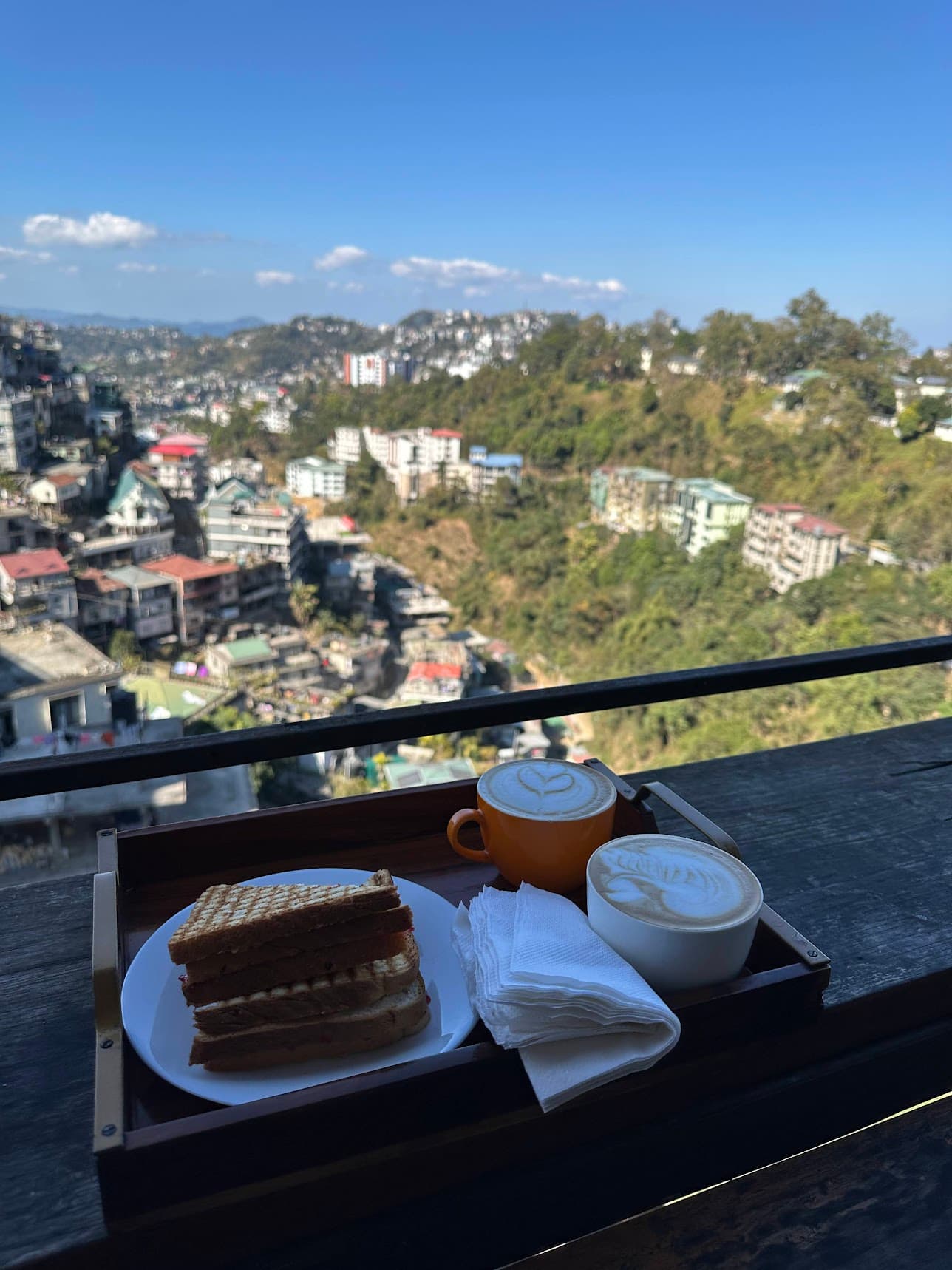 Cafe table overlooking the hills and houses of Aizawl