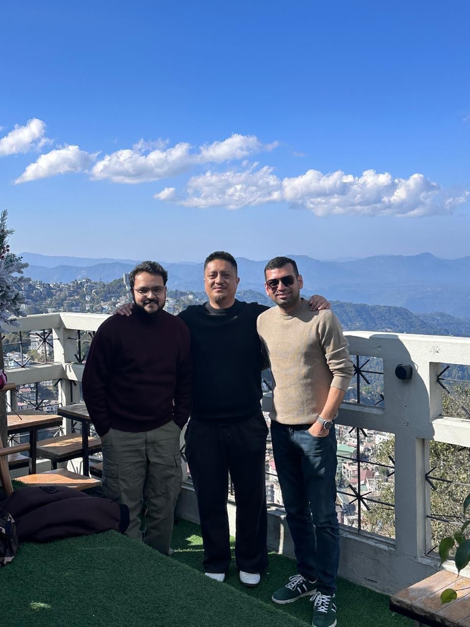 Three travelers standing at a viewpoint in Aizawl