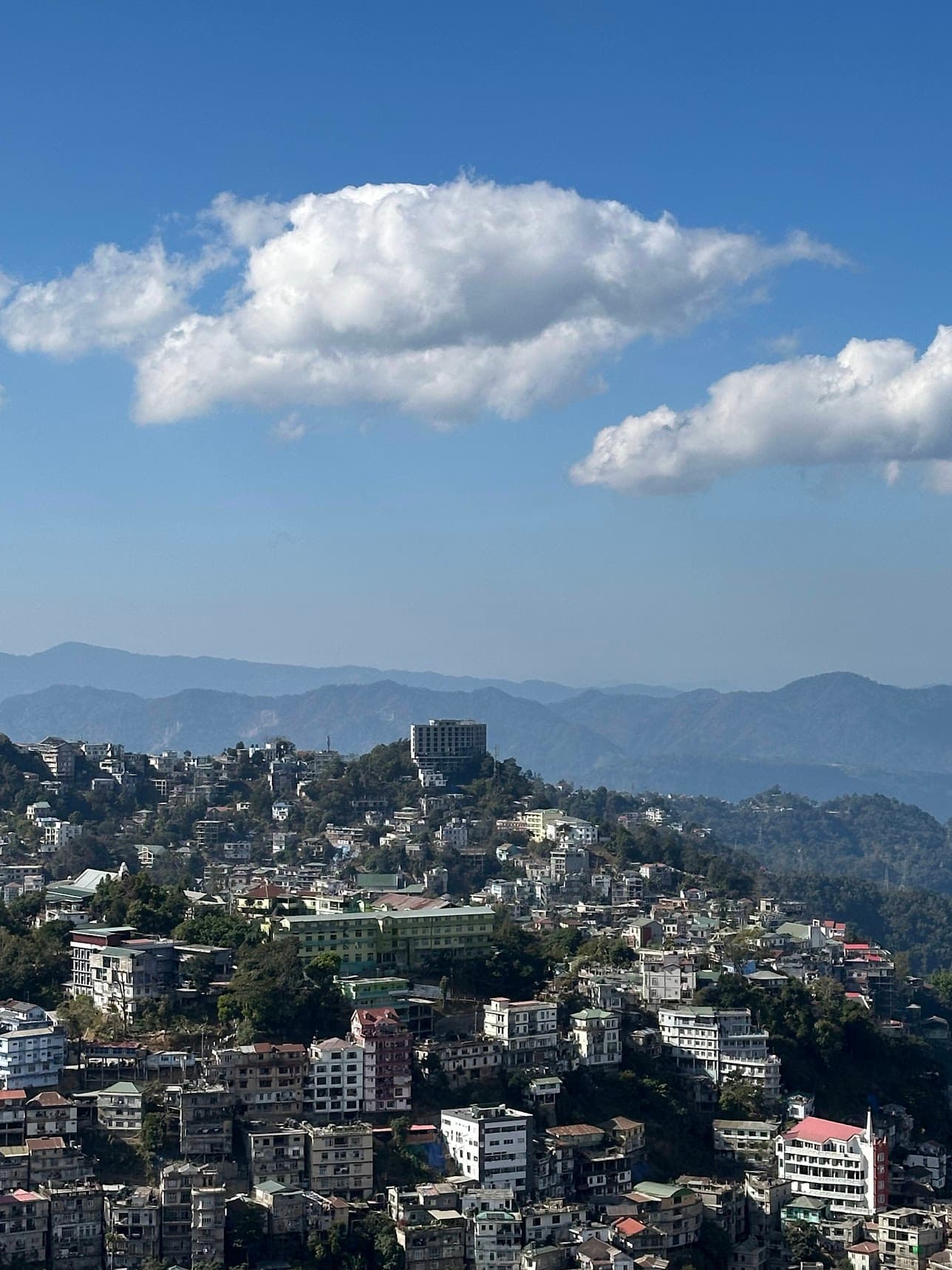Aizawl hillside city view under a clear winter sky