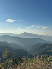 Layered mountain view outside Aizawl under a clear sky