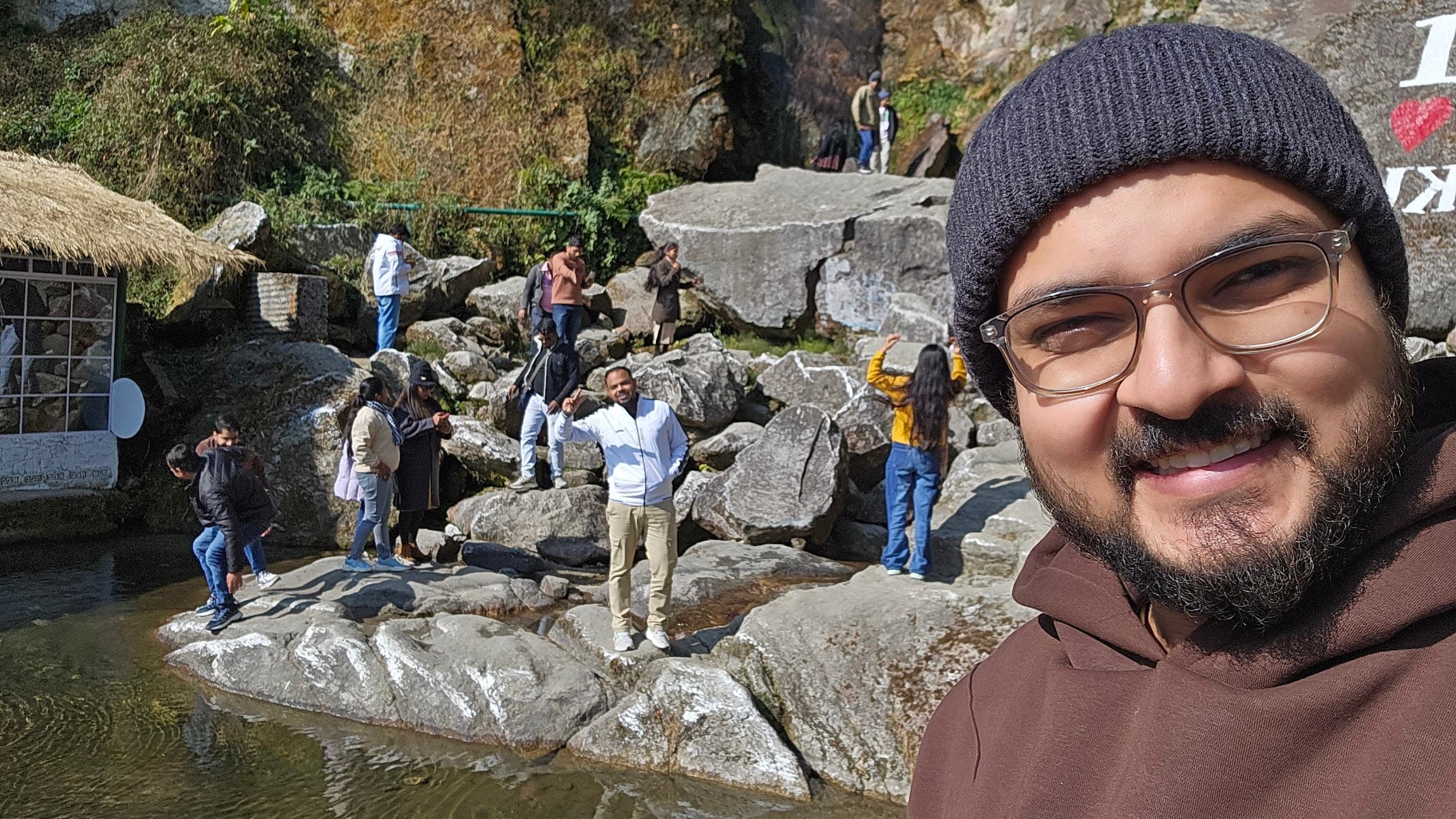 Rocky stream stop near Gangtok with people gathered by the water