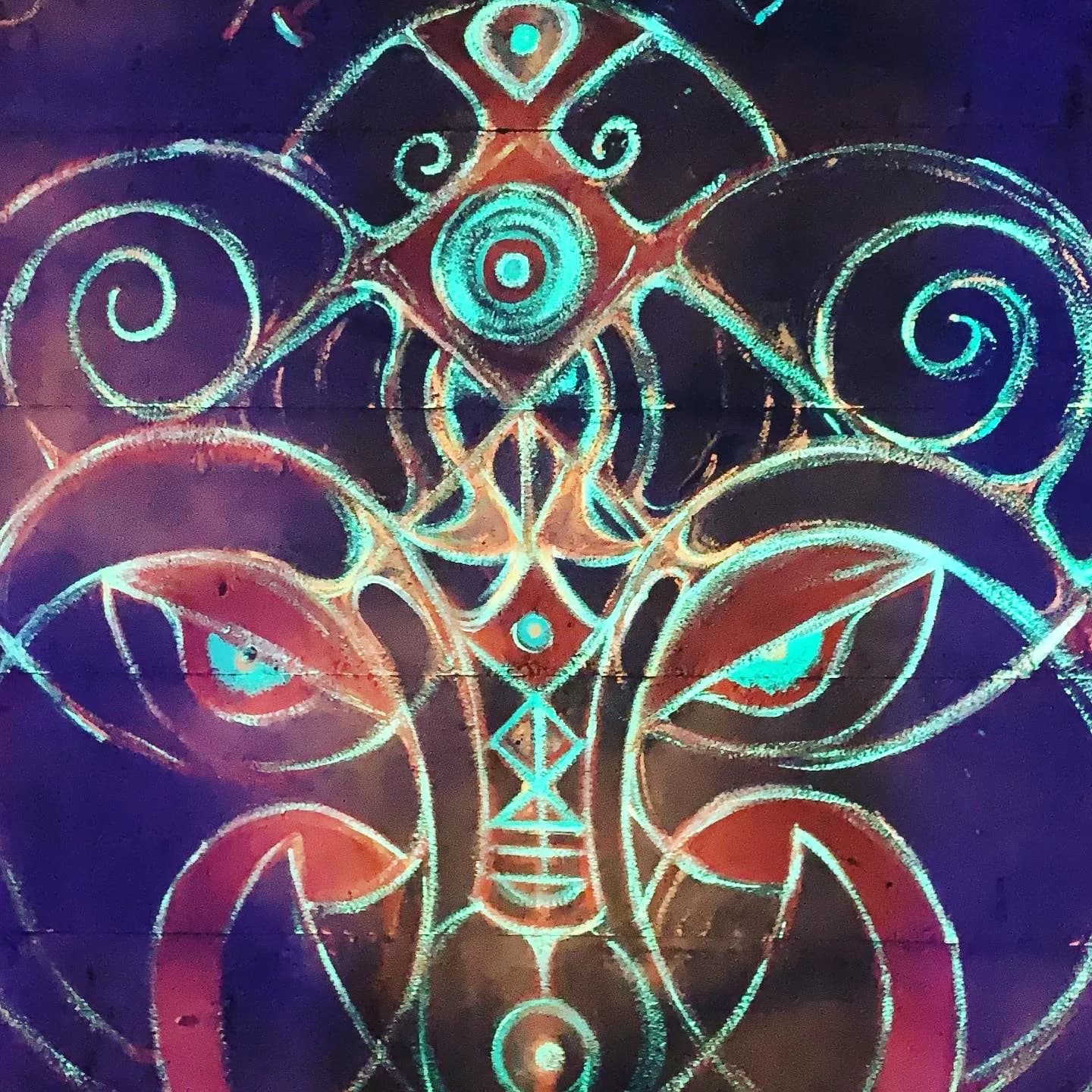 A second colourful psychedelic mural photographed in Auroville