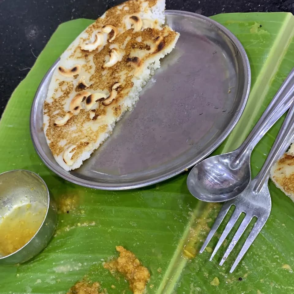 A cashew uttapam served on a banana leaf