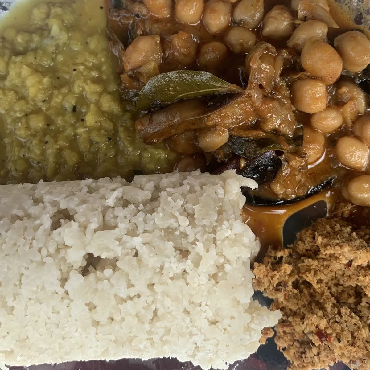 A Sri Lankan meal of rice, lentils, beans, and coconut sambol