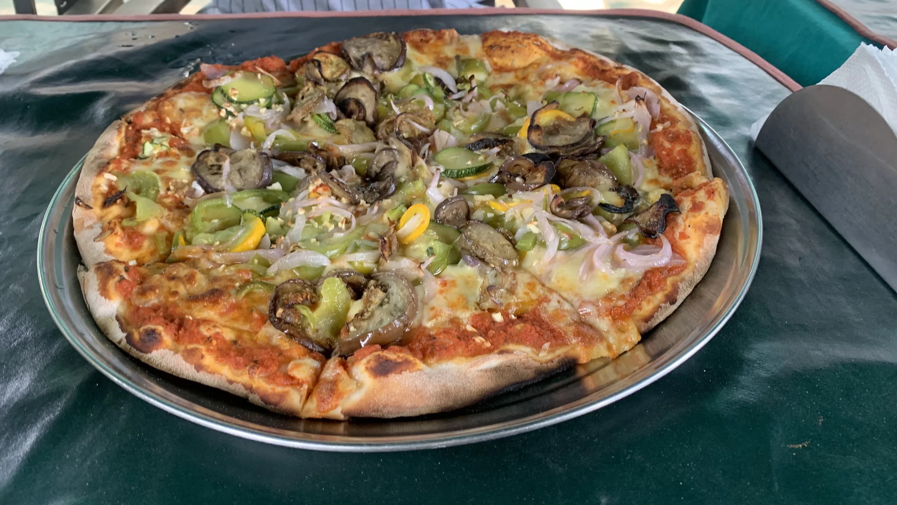 A freshly baked pizza served at Tanto's Pizzeria in Auroville