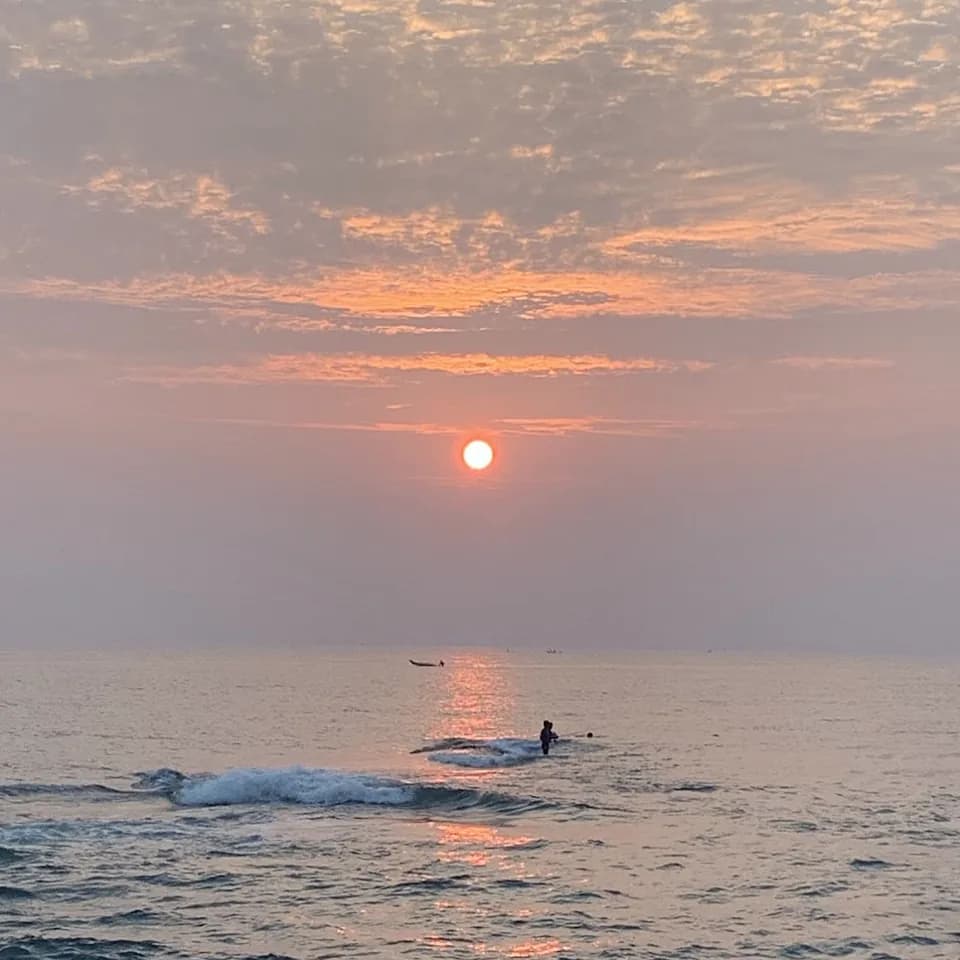 The sun rising over the Bay of Bengal at Rock Beach
